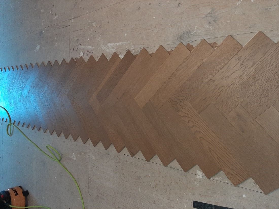 Herringbone hardwood being installed